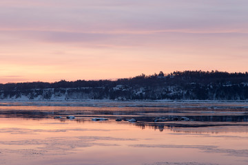 Late winter sunrise view of ice and rocks in the St. Lawrence river, Cap-Rouge area, Quebec City, Quebec, Canada