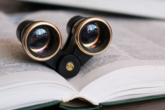 Retro theater binoculars and a book