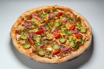 pizza with ham and tomato on plate