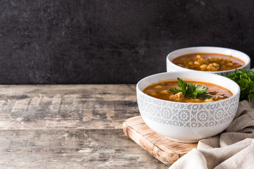 Harira soup in bowl on wooden table. Typical Moroccan food. Ramadán concept. Copyspace
