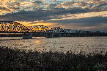 Fototapeta na wymiar Sunset over the bridge over the Vistula river in Grudziadz, Kujawsko-Pomorskie, Poland