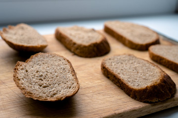 Fototapeta na wymiar Six beautiful sliced pieces of bread on a wooden board on a white background. malt bread
