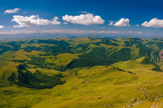View from the Bermamyt Plateau on a summer day. Hills and clouds in the distance. © dmitriydanilov62