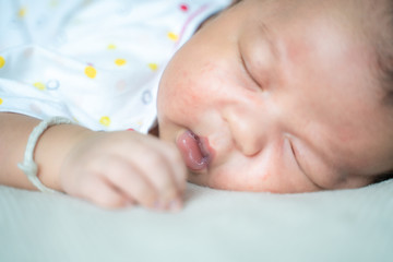 Adorable infant kid sleeping on blanket