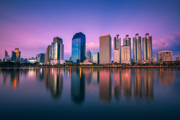 Obraz na płótnie Canvas Panorama view of Benchakitti Park, Cityscape of skyscraper business reflection at Benchakitti park at twilight time in Bangkok, Thailand.