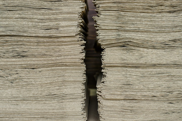 Side View Of Huge Stack of Recycled Paper close up. Business concept. Huge Stack of Recycled Paper envelopes closeup. Eco Kraft paper.