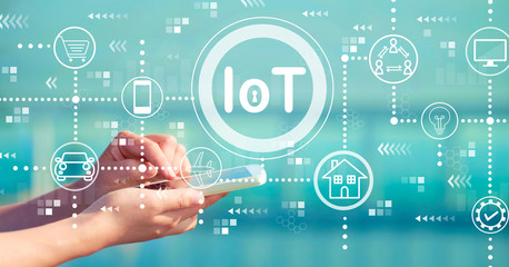 IoT theme with person holding a white smartphone