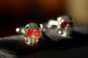 Two silver skulls