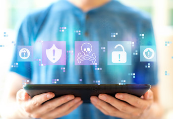 Virus and scam theme with young man using a tablet computer