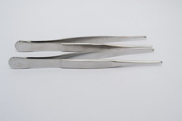 surgical clamp isolated on white surface