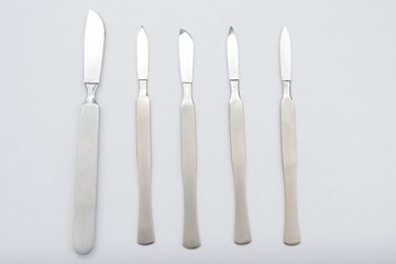 Different One-Piece Scalpels on white background