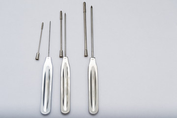 Different types of catheter trocars on grey surface