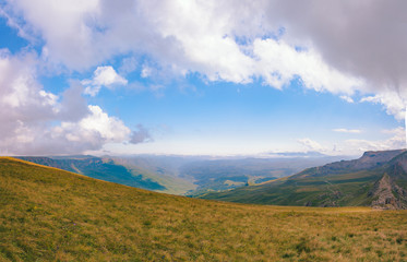 View from the Bermamyt Plateau on a summer day. Hills and clouds in the distance.