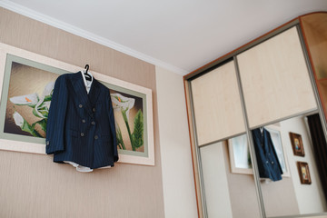 Men's costume hanging in the hanger in the house.