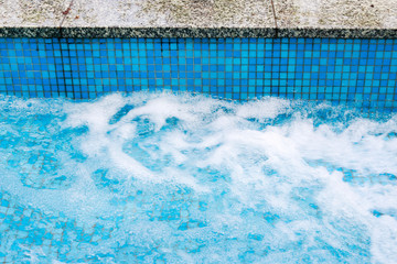 Small waterfall in outdoor pool.