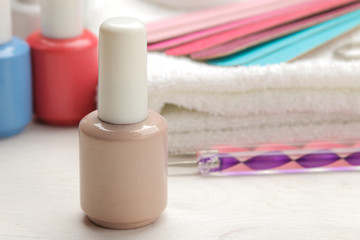 Manicure. nail polishes and various accessories and tools for manicure on a white wooden table