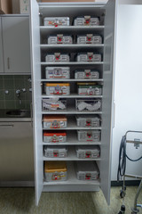 a cabinet full of surgical instruments Container
