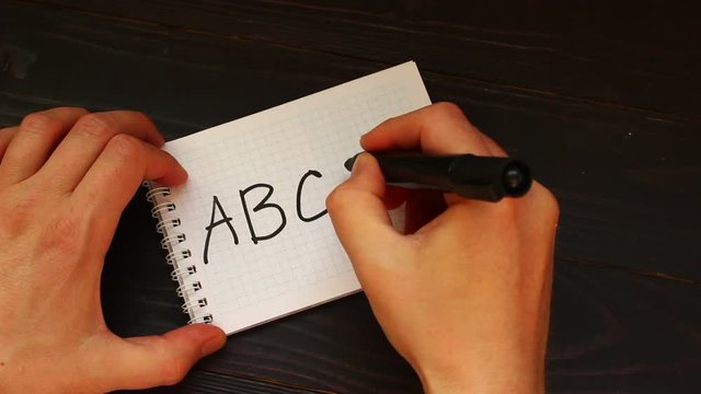 ABCD Hands write a word close-up
