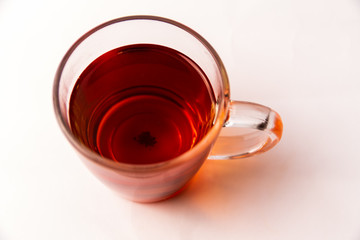 Glass cup filled with black tea isolated on a white background