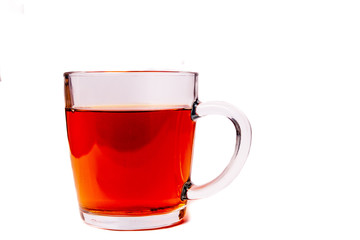 Glass cup filled with black tea isolated on a white background