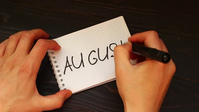 August Hands write a word close-up