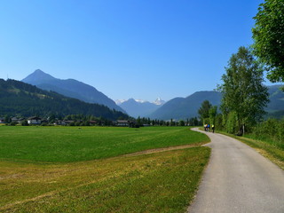 Fototapeta na wymiar Austrian Alps-view on the cyclists in valley near the Pongau