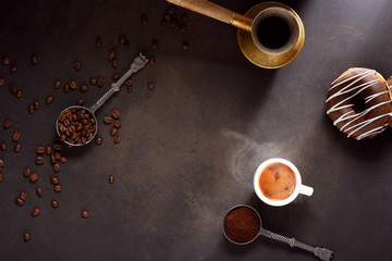Coffee cup and coffee beans on wooden background.
