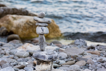 Fototapeta na wymiar concept of harmony and balance with rocks on the beach. in the background a beach