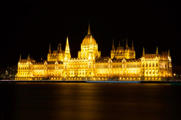 Fototapeta na wymiar BUDAPEST, HUNGARY - MAR 07th, 2019: The Hungarian Parliament Building is the seat of the National Assembly of Hungary at the Danube river during night, one of Europe's oldest legislative buildings