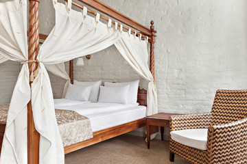 Obraz na płótnie Canvas Luxurious modern bedroom interior with canopy bed
