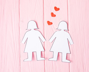 Lesbian Couple Together Concept . Two paper woman on pink background.