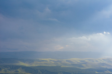 Overcast clouds in the distance over the hills