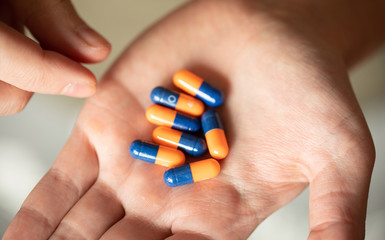 Colorful pills and medicines in the hand 