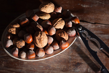 Hazelnut on the wooden plate.