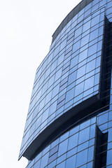 Fototapeta na wymiar Vertical shoot of blue colored glazing facade mass office building