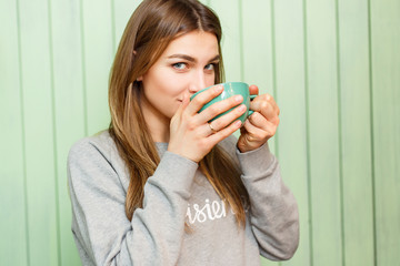 Young blonde woman with coffee mug.