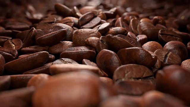 Amazing close-up of coffee beans on a black background. Camera move along the coffee beans (4K,ultra high definition 2160p, seamless loop)