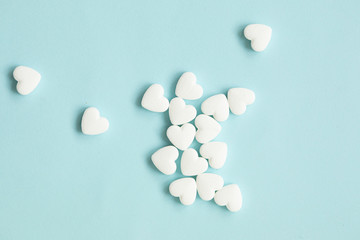 Pills as a heart on blue background