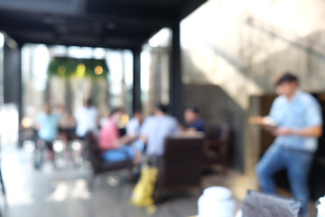 Blurred people working and recreation in modern cafe