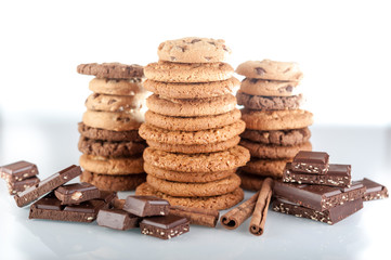 Various shortbread, oat cookies, chocolate chip biscuit and pieces of chocolate with seeds and nuts.