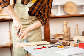 Man with screwdriver working in studio