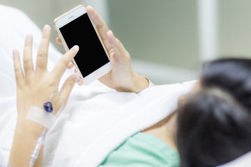 Patient women sickness use smartphone on hospital bed