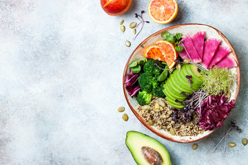Vegan, detox Buddha bowl with quinoa, micro greens, avocado, blood orange, broccoli, watermelon...