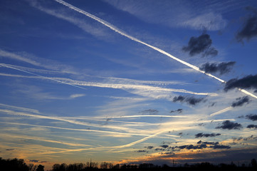 Intersecting roads white plane in the blue sky.