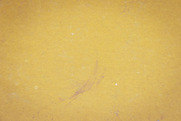 The texture of the surface of the old yellow cardboard. Vignette effect. Empty and shabby background.	