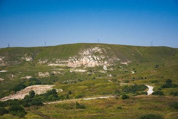 A large panorama of the hilly and mountainous area on a summer day.