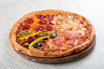 Pizza for children, with sausages and french fries on a wooden board