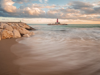 view of a lighthouse on a cloudy day in long exposure