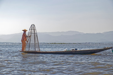 Burma, Asia -  Fisherman in a wooden boat.