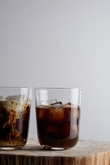 Ice coffee on a wood table with cream.